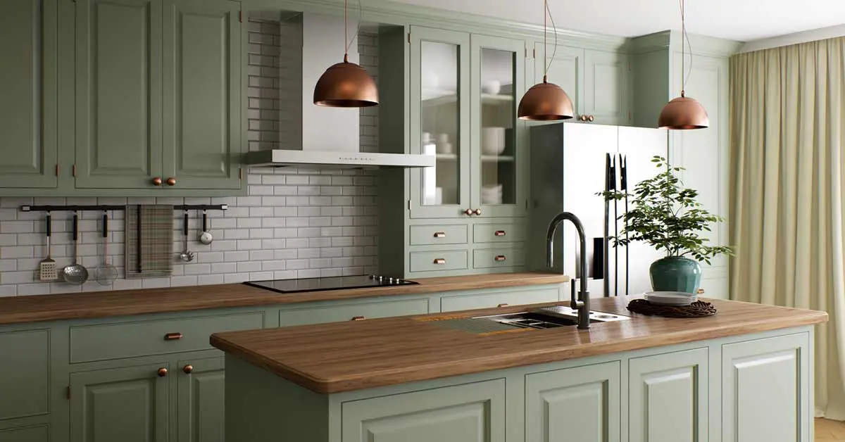 Stylish kitchen remodel featuring green cabinetry, copper pendant lights, and a wood countertop in Colorado Springs