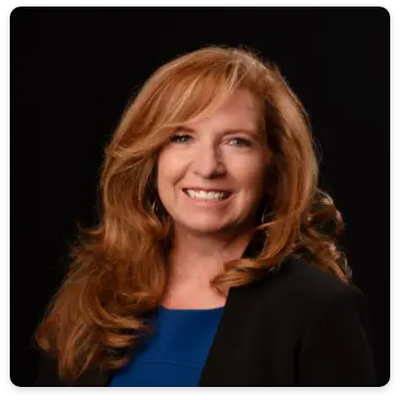 DreamMaker Colorado Springs designer Sarah Pinkerton smiles warmly in a professional headshot, showcasing her expertise