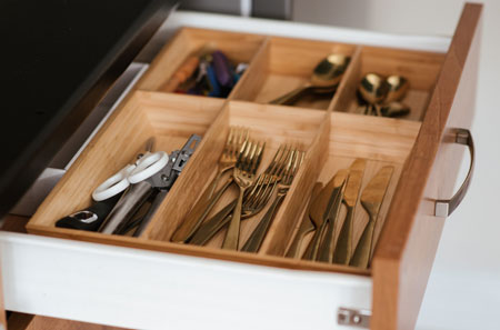 Organized kitchen drawer in Lake Norman featuring utensil dividers for convenient and efficient storage