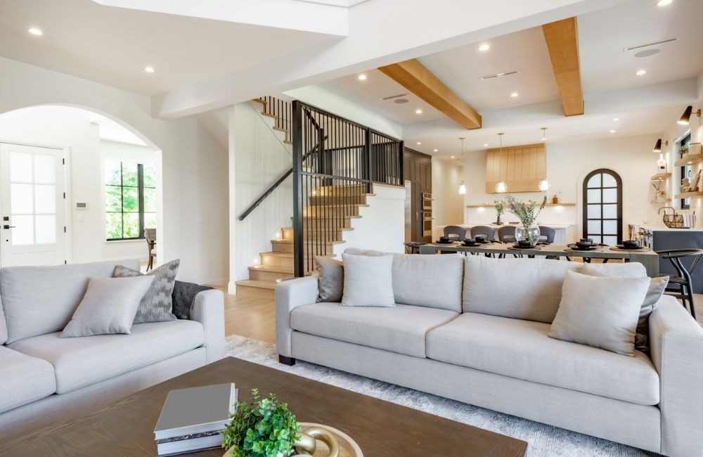 Stylish open-concept living room and kitchen remodel in Schaumburg, featuring a modern staircase and neutral colors