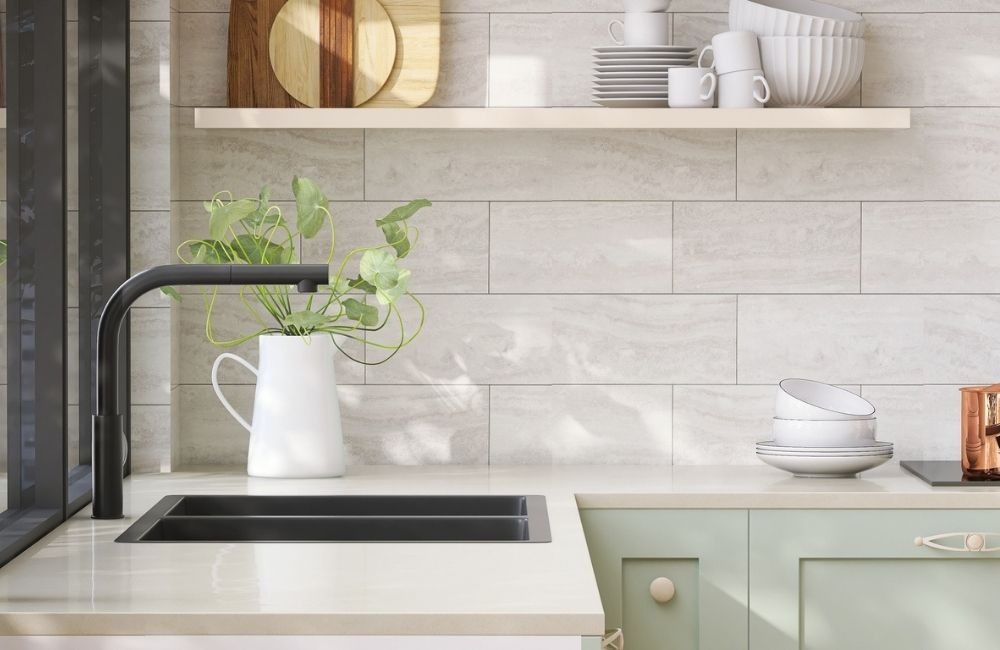 Modern kitchen in Schaumburg featuring a light tile backsplash, dark faucet, and green cabinetry