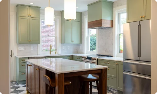 Stylish kitchen remodel featuring sage green cabinetry, a wood island, and stainless steel appliances in Schaumburg
