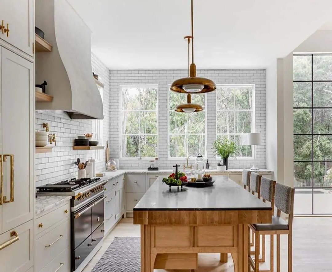 Bright, modern kitchen remodel in South Valley featuring white cabinetry, brick backsplash, and large windows overlooking greenery.