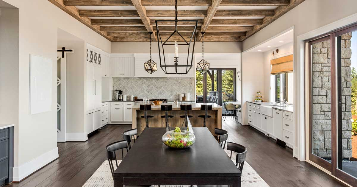 Stylish kitchen design featuring dark wood flooring, white cabinetry, and modern pendant lighting in St. George
