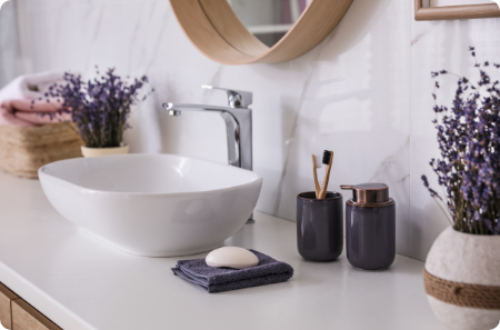 Modern bathroom vanity with white vessel sink, chrome faucet, and decorative accents in St. George.