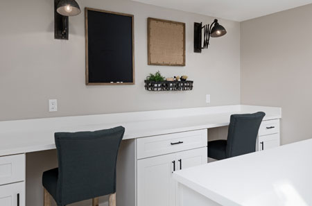 DreamMaker kitchen remodel featuring a white countertop and cabinetry, with wall-mounted lighting and decorative accents in St. George