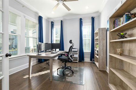 Stylish home office addition with built-in shelving and dual computer monitors, showcasing DreamMaker remodeling in St. George