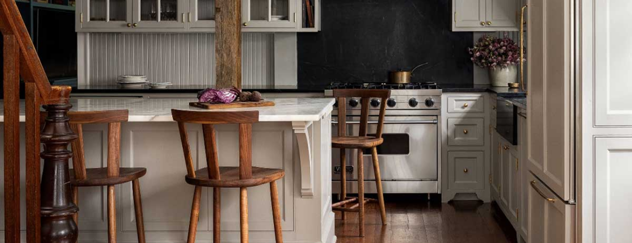 Stylish kitchen remodel featuring white cabinetry, marble countertops, and a stainless steel range, showcasing DreamMaker's remodeling in St. Louis Park