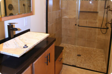 Accessible bathroom remodel in St. Louis Park, featuring a curbless shower, grab bar, and modern sink